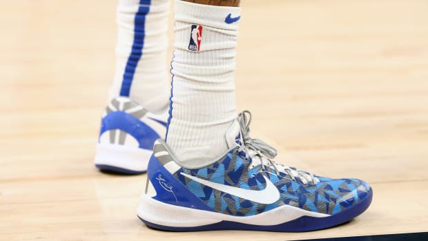 View of white and blue Nike Kobe shoes.