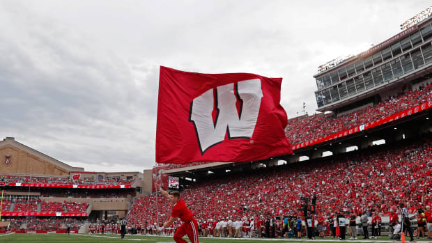 The Wisconsin flag being waved after a scoring play at Camp Randall Stadium.