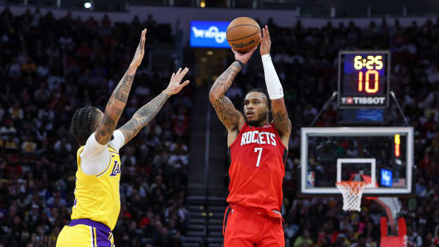 Rockets forward Cam Whitmore (7) shoots the ball as Los Angeles Lakers guard D'Angelo Russell (1) defends during the second quarter at Toyota Center.
