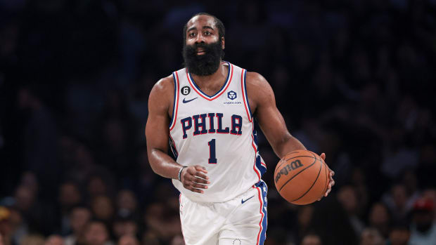 Philadelphia 76ers guard James Harden dribbles up the court during a game.