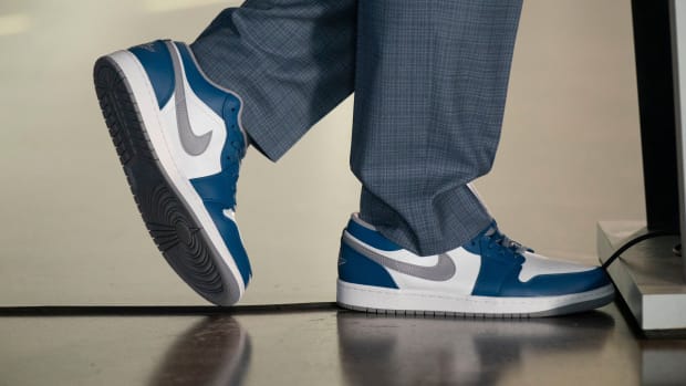 View of white, blue, and grey Air Jordan shoes.