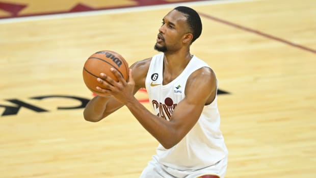 Feb 26, 2023; Cleveland, Ohio, USA; Cleveland Cavaliers forward Evan Mobley (4) shoots a three-point basket in the fourth quarter against the Toronto Raptors at Rocket Mortgage FieldHouse. Mandatory Credit: David Richard-USA TODAY Sports