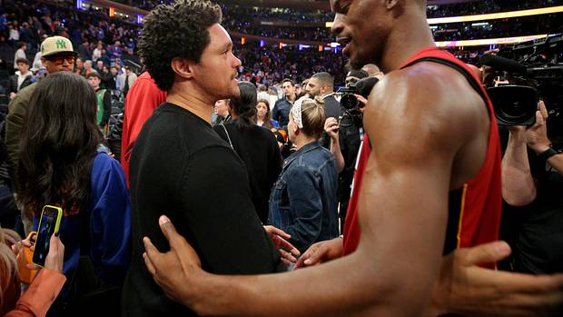 Trevor Noah talks to Miami Heat forward Jimmy Butler after a game.