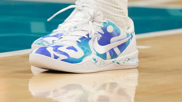 Charlotte Hornets forward Brandon Miller's white and teal Nike shoes.