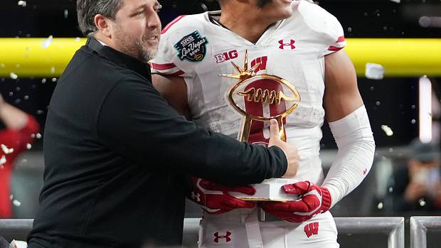 Wisconsin running back Braelon Allen holding the Las Vegas Bowl MVP trophy.