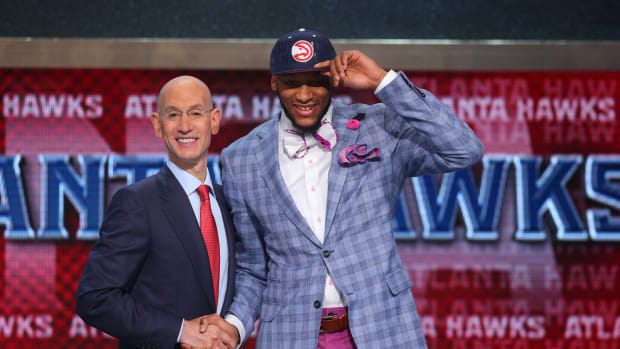 Adreian Payne (Michigan State) shakes hands with NBA commissioner Adam Silver after being selected as the number fifteen overall pick to the Atlanta Hawks in the 2014 NBA Draft at the Barclays Center.
