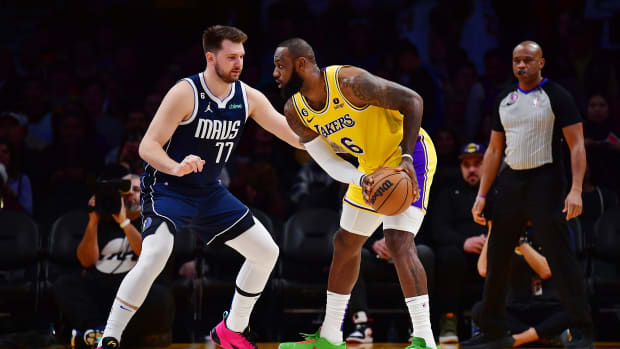 Mavericks guard Luka Doncic defends Lakers forward LeBron James.