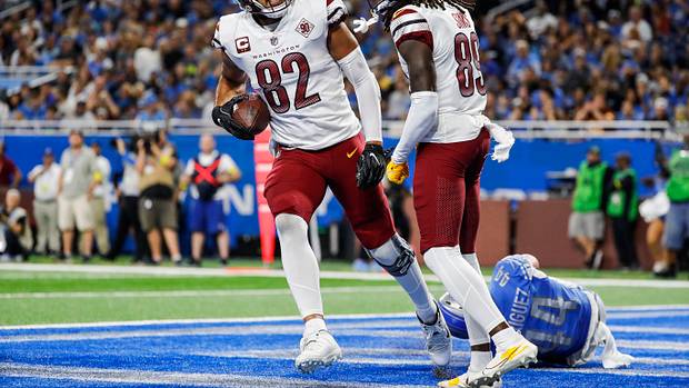Washington Commanders tight end Logan Thomas (82) and receiver Cam Sims (89) celebrate a play against the Detroit Lions.