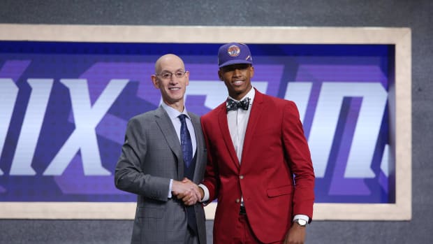 Adam Silver poses for a picture with Jarrett Culver on the stage at the NBA draft.