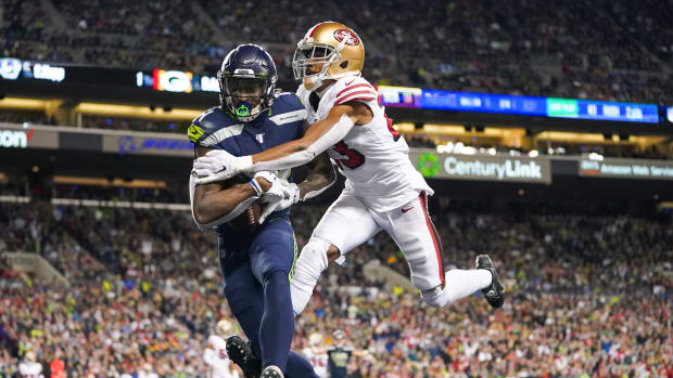 Seattle Seahawks wide receiver D.K. Metcalf (14) catches a touchdown against San Francisco 49ers cornerback Ahkello Witherspoon (23) during the fourth quarter at CenturyLink Field.