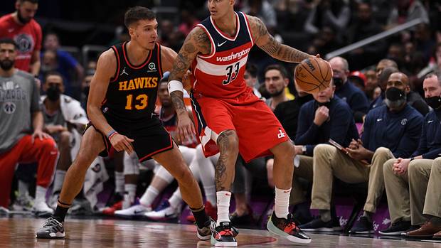 Wizards forward Kyle Kuzma dribbles into Hawks guard Bogdan Bogdanovic.