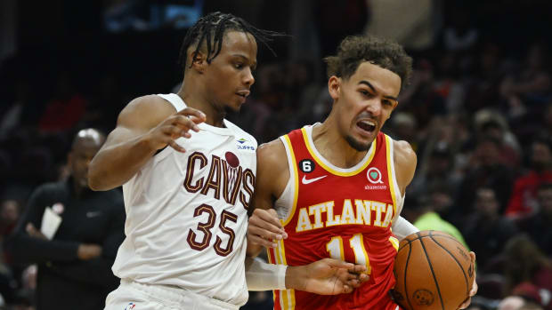 Trae Young drives to the basket against Cavaliers forward Isaac Okoro.
