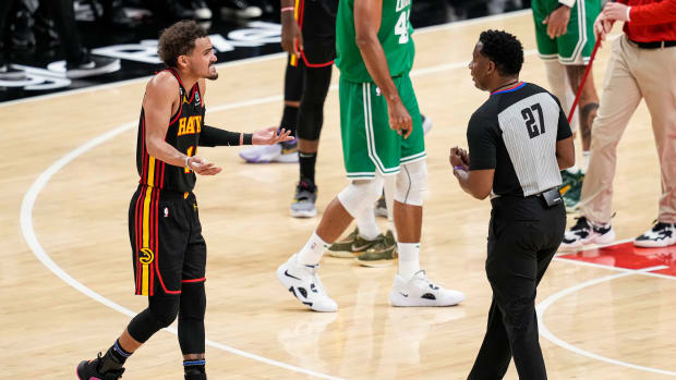 Atlanta Hawks guard Trae Young questions a referee during a timeout.