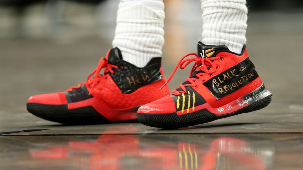 View of red and black Nike Kyrie shoes.