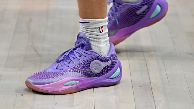 Los Angeles Lakers guard Austin Reaves' purple and teal sneakers.