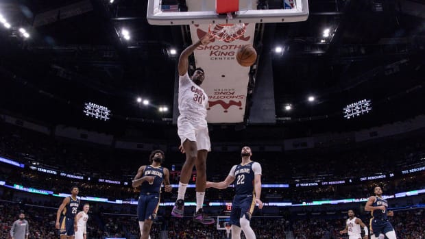 Mar 13, 2024; New Orleans, Louisiana, USA; Cleveland Cavaliers center Damian Jones (30) drives to the basket against New Orleans Pelicans forward Larry Nance Jr. (22) during the second half at Smoothie King Center. Mandatory Credit: Stephen Lew-USA TODAY Sports