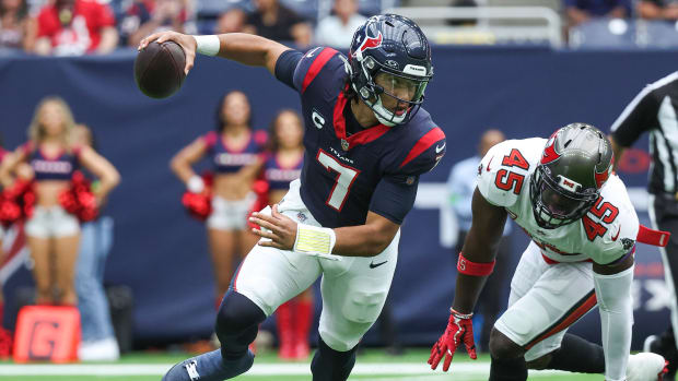 Texans quarterback C.J. Stroud (7) scrambles with the ball as Tampa Bay Buccaneers linebacker Devin White (45) applies defensive pressure during the first quarter at NRG Stadium.
