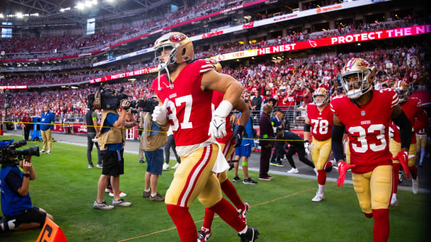 San Francisco 49ers defensive end Nick Bosa runs onto the field.