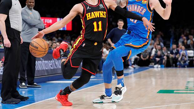 Hawks guard Trae Young is fouled by Thunder guard Vit Krejci.