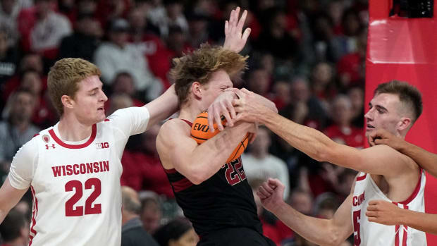 Tyler Wahl tries to pry the ball away from the Stanford offensive player