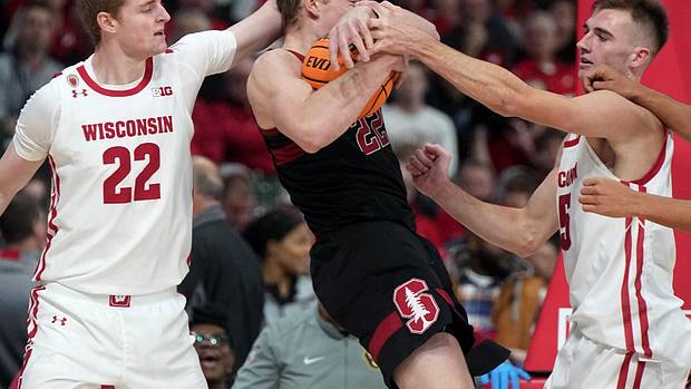 Tyler Wahl tries to pry the ball away from the Stanford offensive player