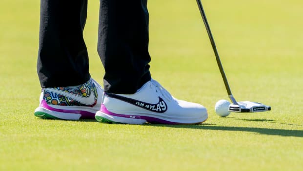 View of Rory McIlroy's white, green, and purple Nike golf shoes.
