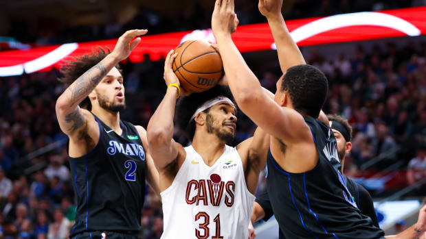 Dec 23, 2023; Dallas, Texas, USA; Cleveland Cavaliers center Jarrett Allen (31) looks to shoot as Dallas Mavericks center Dereck Lively II (2) and Dallas Mavericks forward Grant Williams (3) defend during the second quarter at American Airlines Center. Mandatory Credit: Kevin Jairaj-USA TODAY Sports