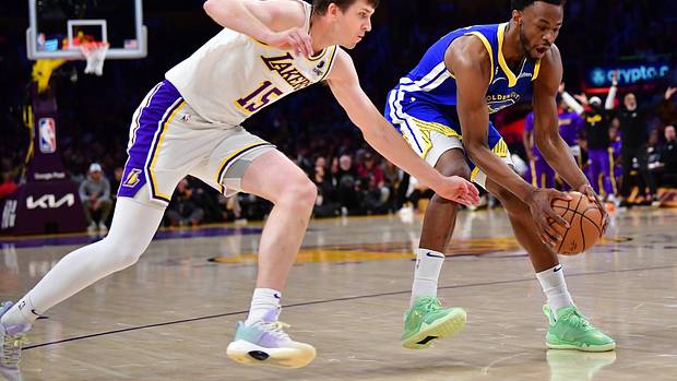 Lakers guard Austin Reaves tries to steal the ball from Warriors guard Andrew Wiggins.