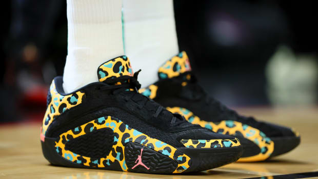 Boston Celtics forward Jayson Tatum's black and gold Jordan Brand sneakers.