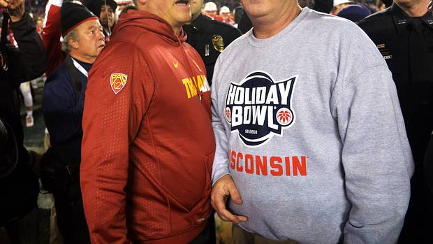 Paul Chryst speaking with USC head coach Clay Helton after the Holiday Bowl.