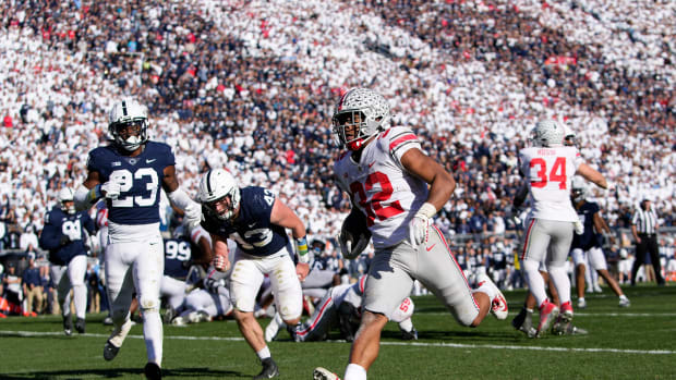 Ohio State Buckeyes running back TreVeyon Henderson (32) runs for a 7-yard touchdown past Penn State Nittany Lions linebacker Tyler Elsdon (43) and linebacker Curtis Jacobs (23) during the fourth quarter