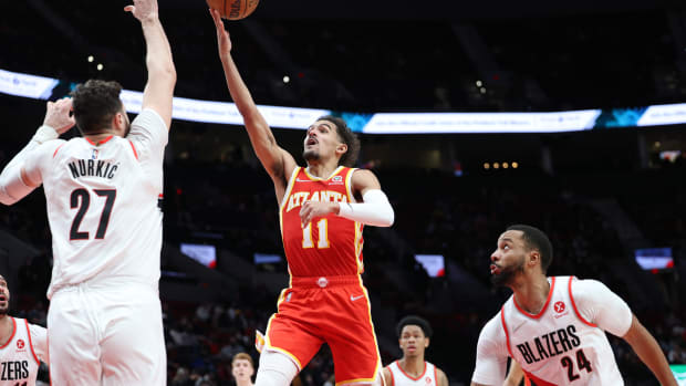 Hawks guard Trae Young shoots over Trail Blazers center Jusuf Nurkic.