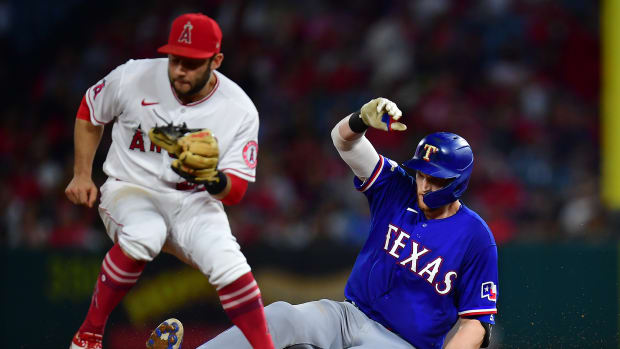 Sep 30, 2022; Anaheim, California, USA; Texas Rangers catcher Sam Huff (55) reaches second on a double ahead of Los Angeles Angels second baseman David Fletcher (22) during the fifth inning at Angel Stadium. Mandatory Credit: Gary A. Vasquez-USA TODAY Sports
