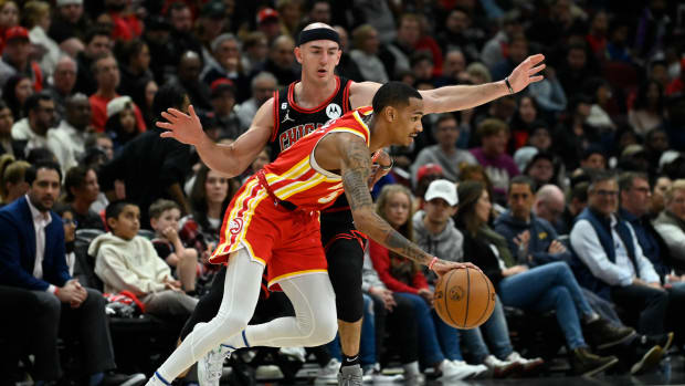 Chicago Bulls guard Alex Caruso defends against Atlanta Hawks guard Dejounte Murray.