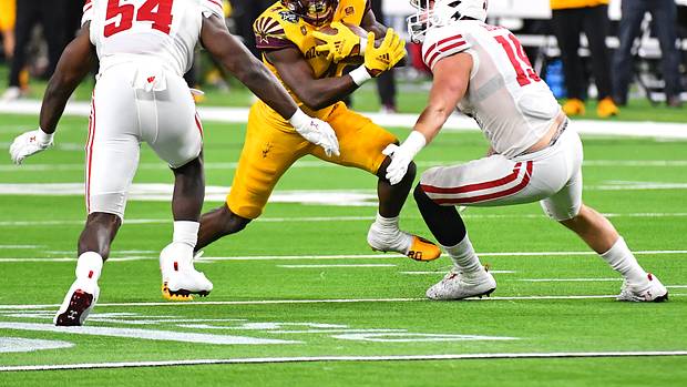 Wisconsin linebackers Jordan Turner and Nick Herbig tackle an Arizona State runner in the Las Vegas Bowl.