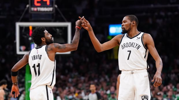 Brooklyn Nets guard Kyrie Irving (11) and forward Kevin Durant (7) react after a play against the Boston Celtics in the second half during game one of the first round for the 2022 NBA playoffs at TD Garden.