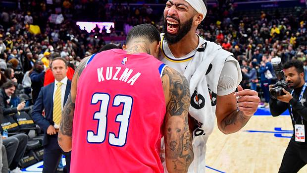 Los Angeles Lakers forward Anthony Davis reacts with Washington Wizards forward Kyle Kuzma after the game at Capital One Arena.