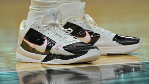 White and black Nike Kobe 5 shoes.
