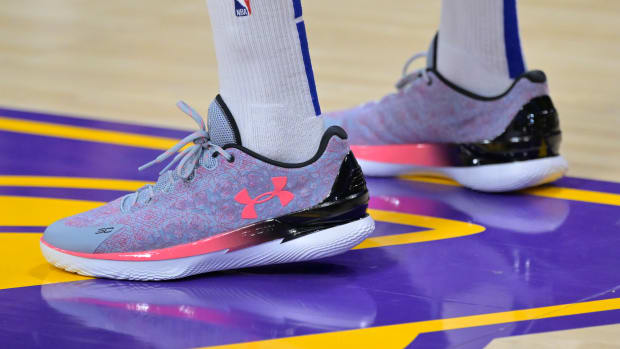 Side view of Stephen Curry's purple and pink Under Armour shoes.