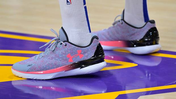 Side view of Stephen Curry's purple and pink Under Armour shoes.