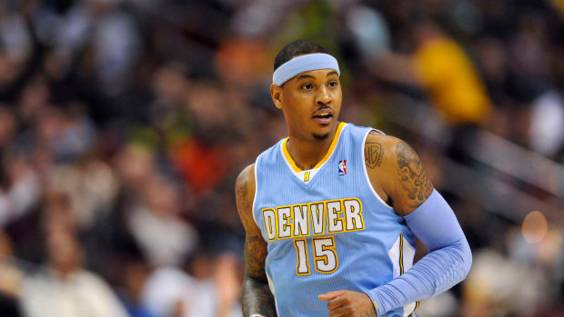 Denver Nuggets forward Carmelo Anthony runs down the court during an NBA game.