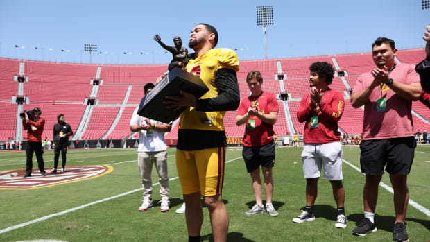 Caleb Williams holds the Heisman Trophy during the USC Trojans Spring Game.