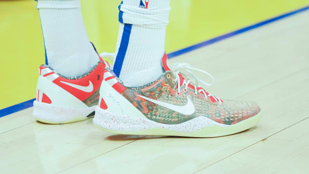 View of white and red Nike Kobe shoes.