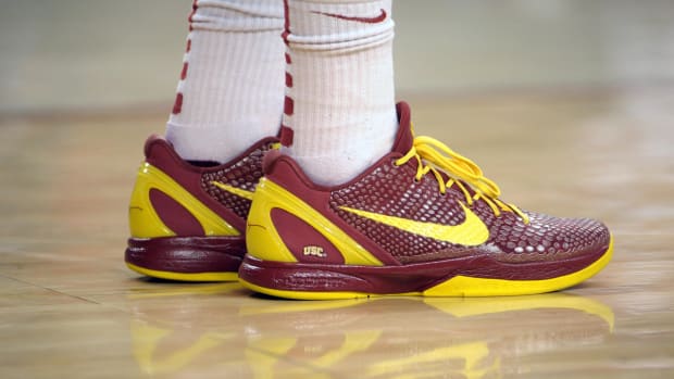 View of cardinal and gold Nike Kobe shoes.