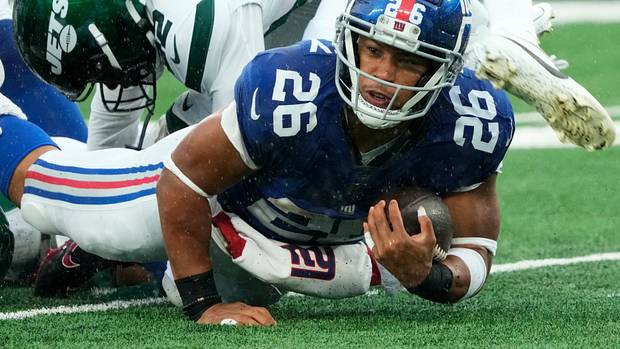 Barkley (26) is shown with the ball against the Jets. The Giants' star running back is on the verge of hitting free agency and there is plenty of debate over his uncertain future with Big Blue.