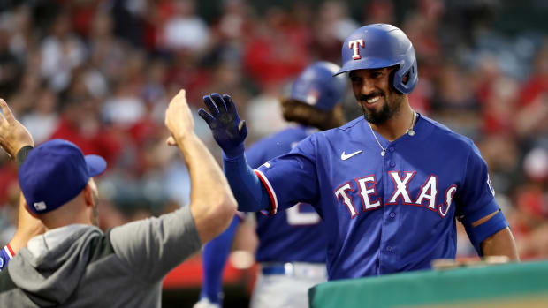 Jul 29, 2022; Anaheim, California, USA; Texas Rangers shortstop Marcus Semien (2) congratulated by a teammate after scoring a run in the sixth inning against the Los Angeles Angels at Angel Stadium. Mandatory Credit: Kiyoshi Mio-USA TODAY Sports