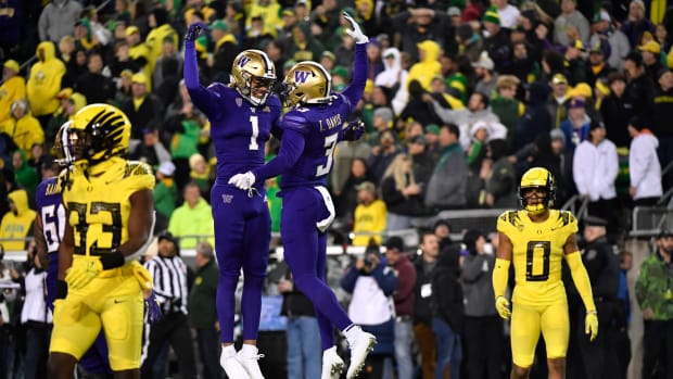 Washington wide receiver Taj Davis celebrates with wide receiver Rome Odunze after scoring in the second half.