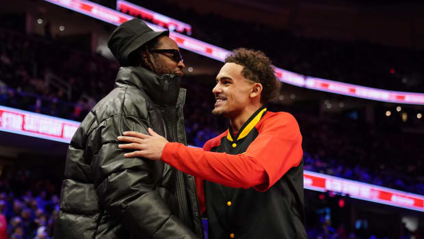 Feb 19, 2022; Cleveland, OH, USA; Atlanta Hawks guard Trae Young (11) greets recording artist 2-Chainz before the 3-Point Contest during the 2022 NBA All-Star Saturday Night at Rocket Mortgage Field House