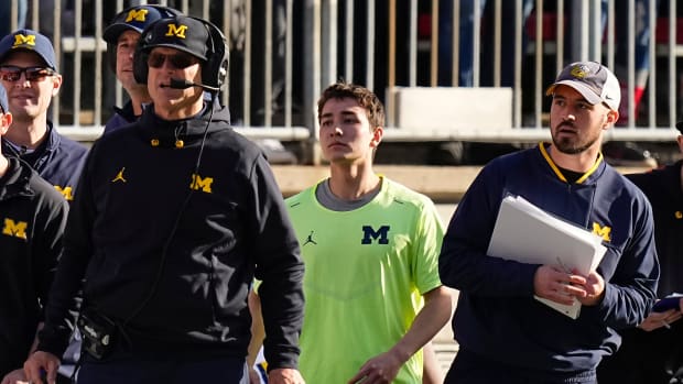 Michigan Wolverines head coach Jim Harbaugh watches from the sideline beside off-field analyst Connor Stalions, right, during the NCAA football game against the Ohio State Buckeyes at Ohio Stadium