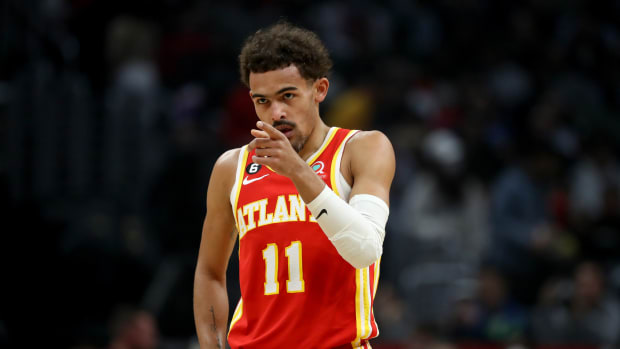 Atlanta Hawks guard Trae Young points to a teammate during a game.